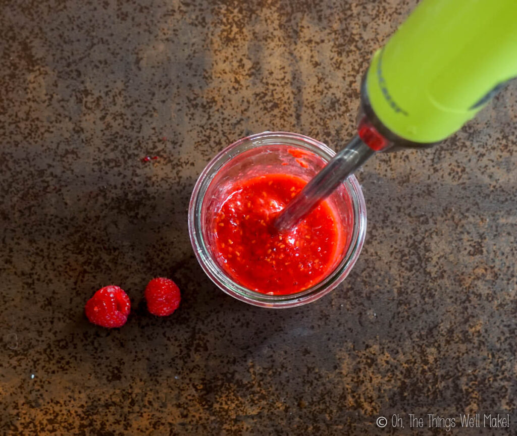 Blending the raspberries with an immersion blender