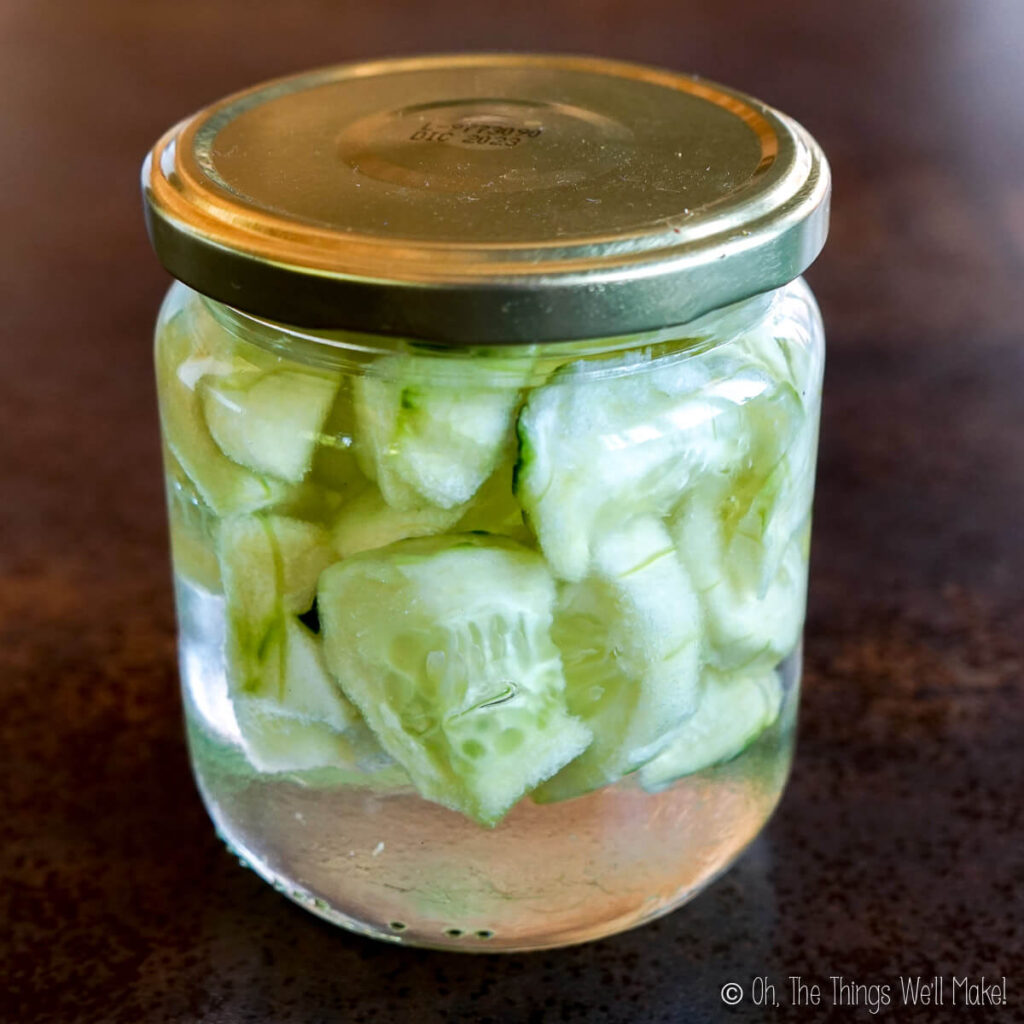 A jar with green cucumber slices in glycerin