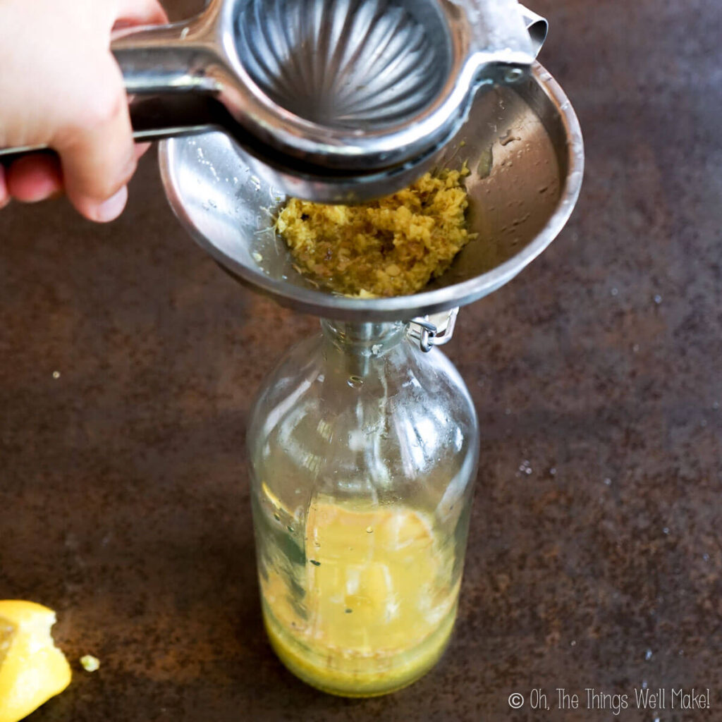 Squeezing lemon juice into a funnel over a bottle