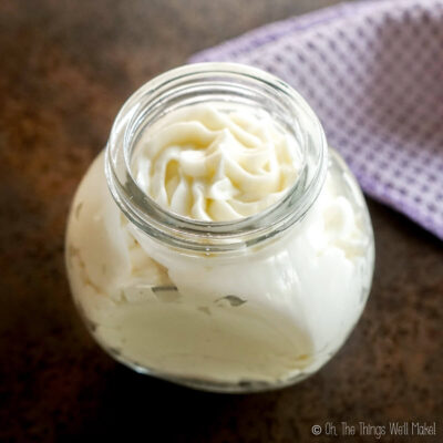 Overhead view of an emulsified body butter in a jar.