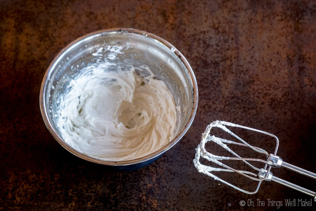 whipped body butter in a bowl next to beaters