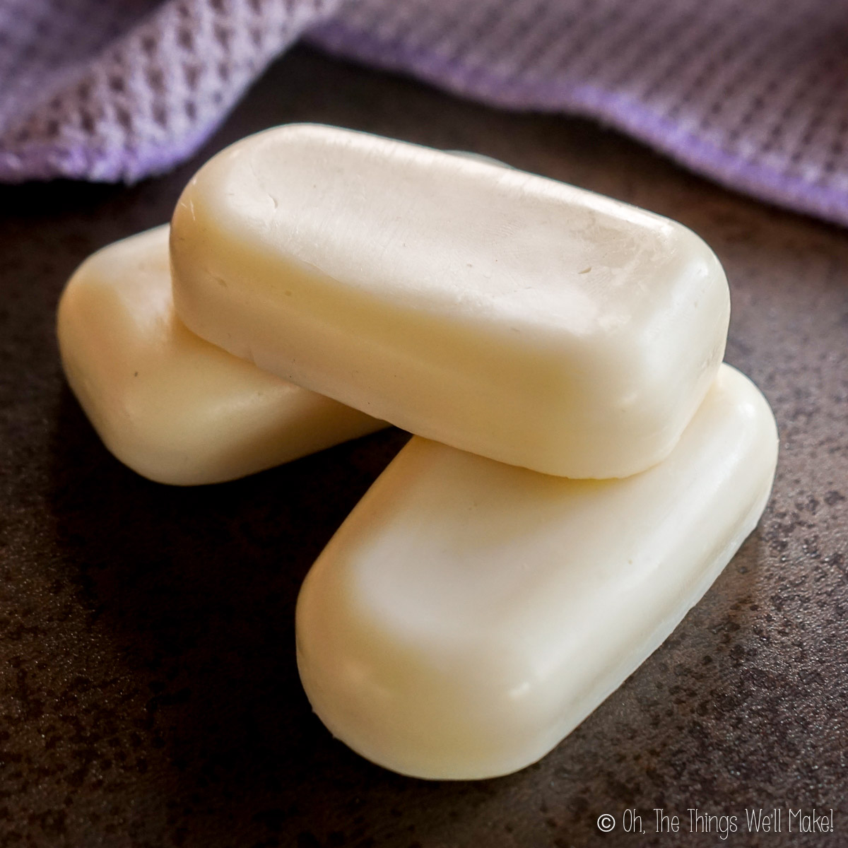 three lotion bars stacked on each other
