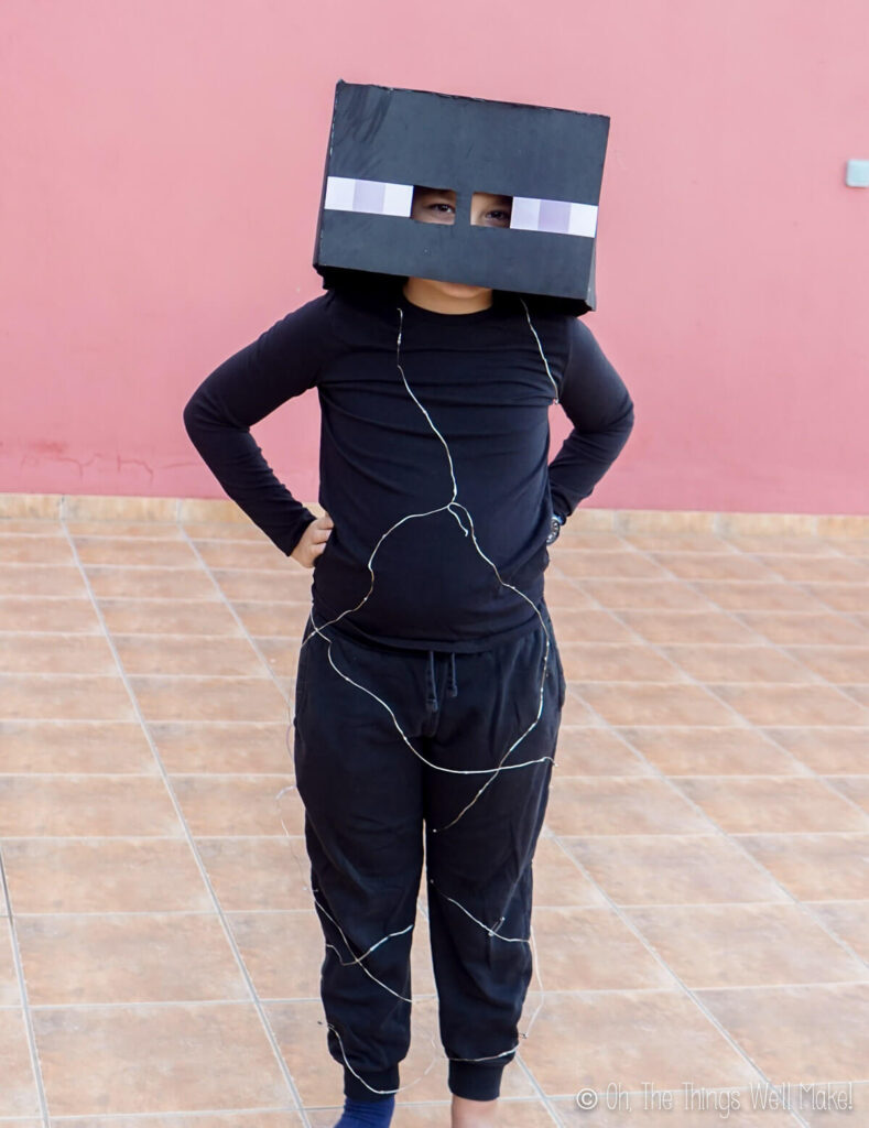 Boy in enderman costume with LED lights