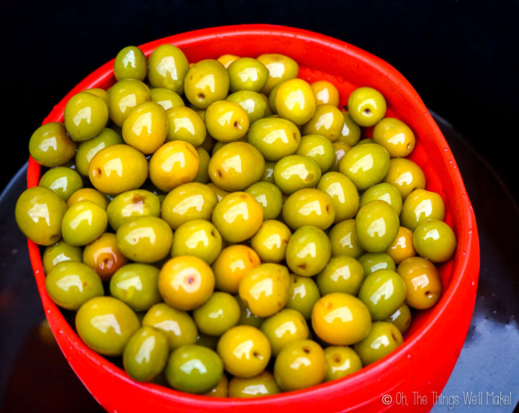 lye treated olives in a silicone strainer (they are golden colored)