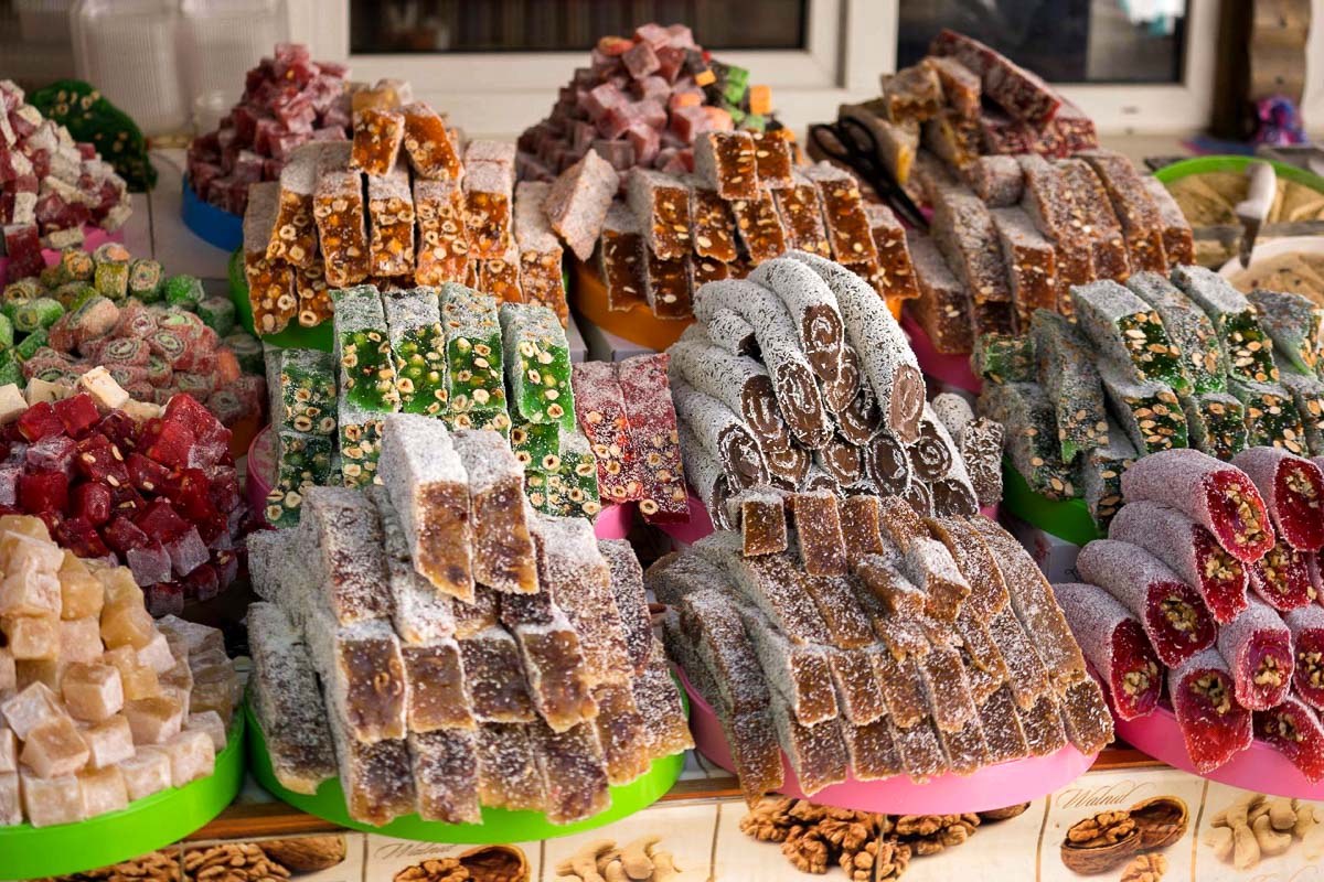 Many stacked Turkish delight candies at a market
