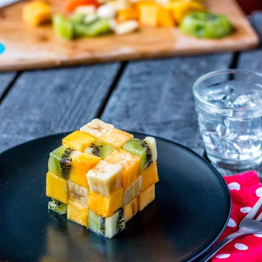 A rubik's cube fruit salad made from cubes of fruit.