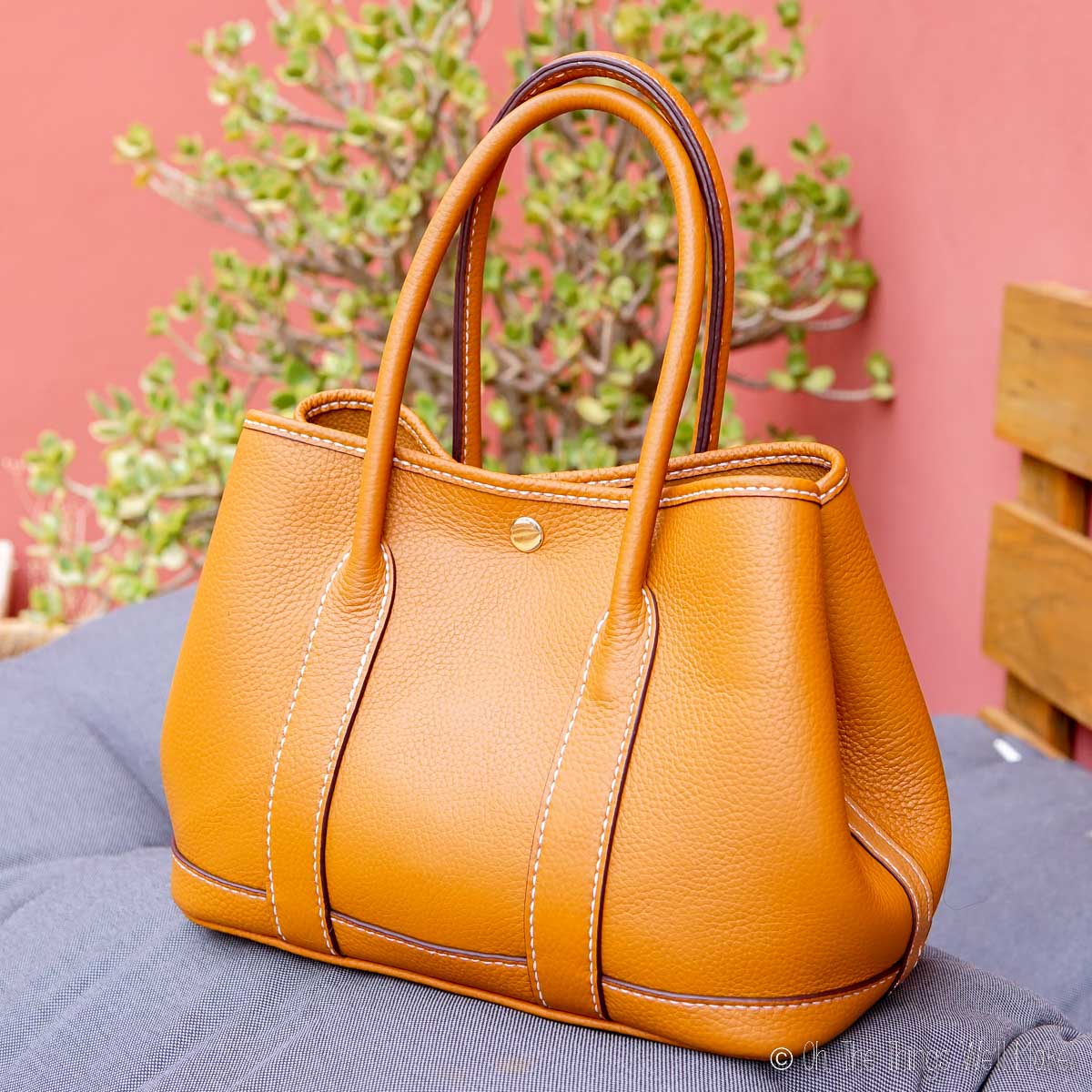 A caramel colored leather purse