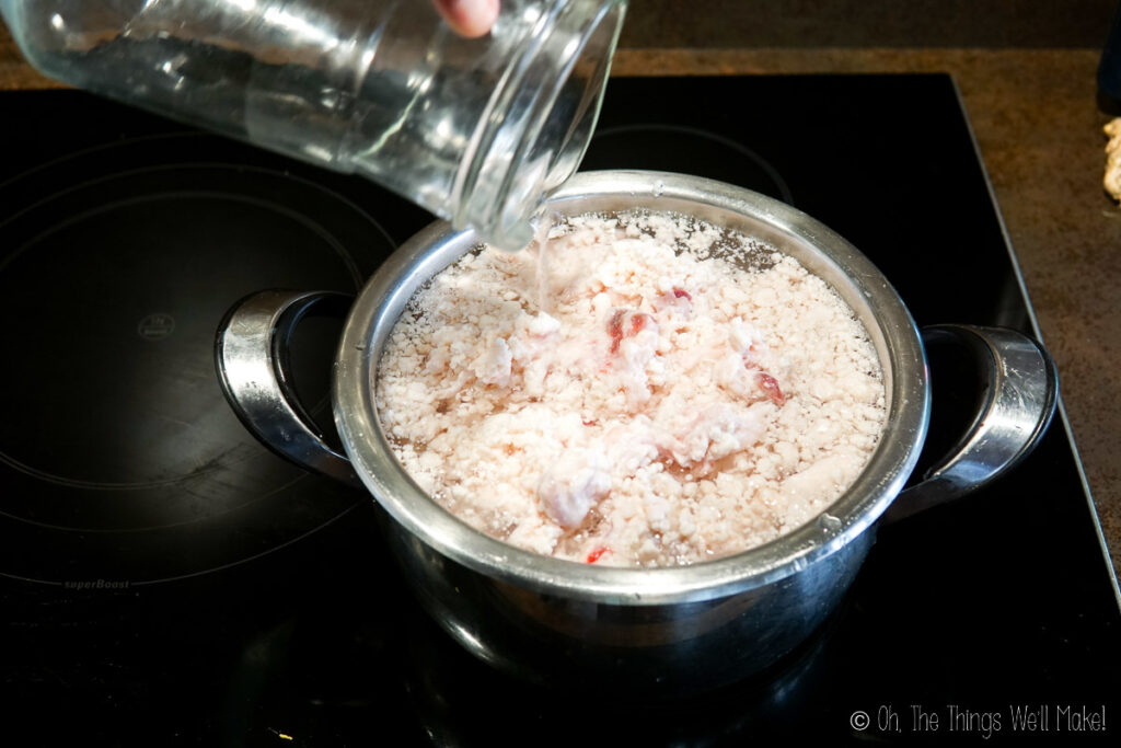 Adding water to a pot of beef fat