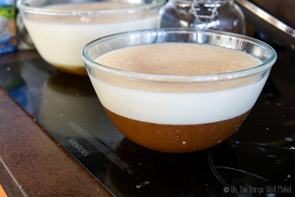 A bowl of tallow with dark liquid below it.