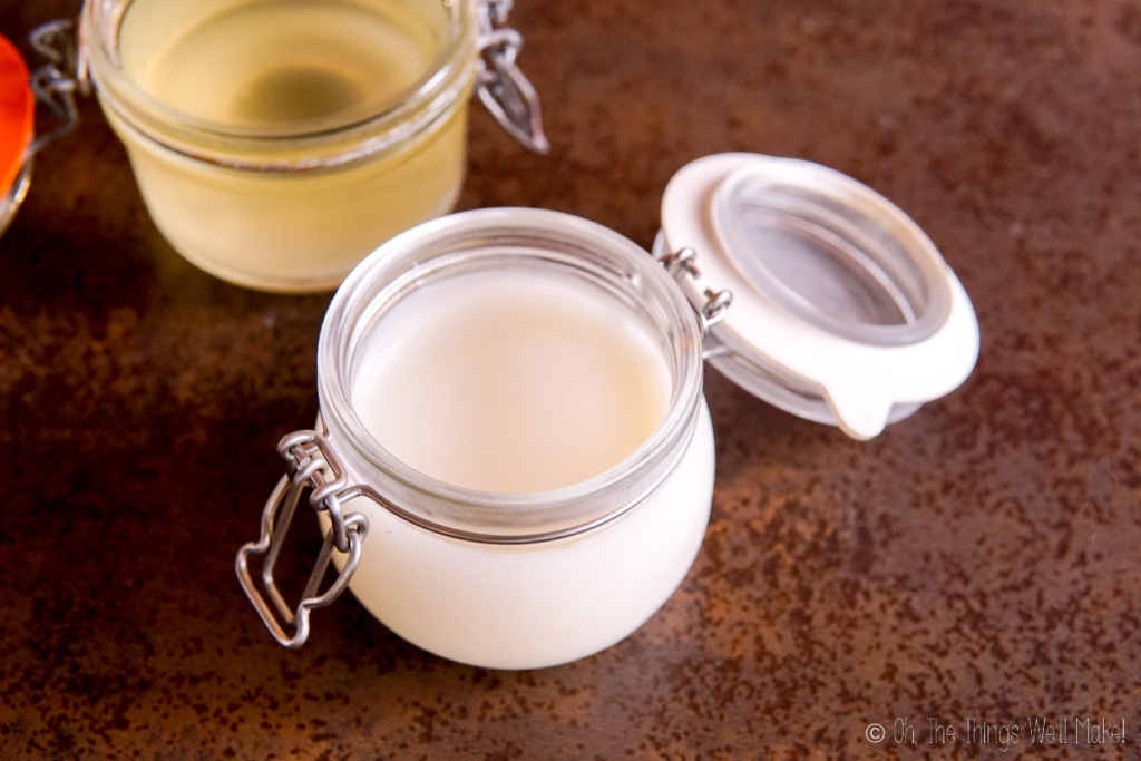 A jar of beef tallow in front of a jar of melted tallow