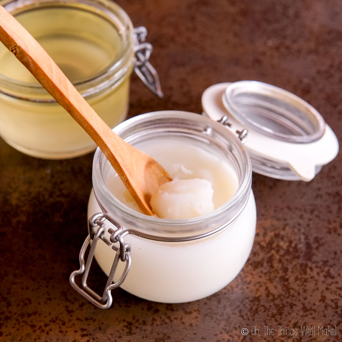 Beef tallow in a jar with a wooden spoon