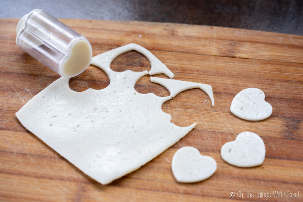 Cutting out cheese hearts using a heart-shaped cookie cutter