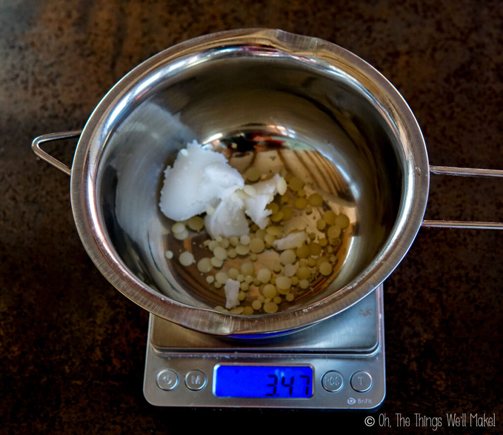 Overhead view of a double boiler insert with tallow and beeswax on a scale