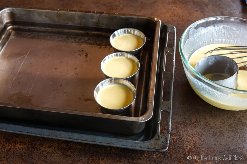 3 custard cups filled with a custard mixture in a pan