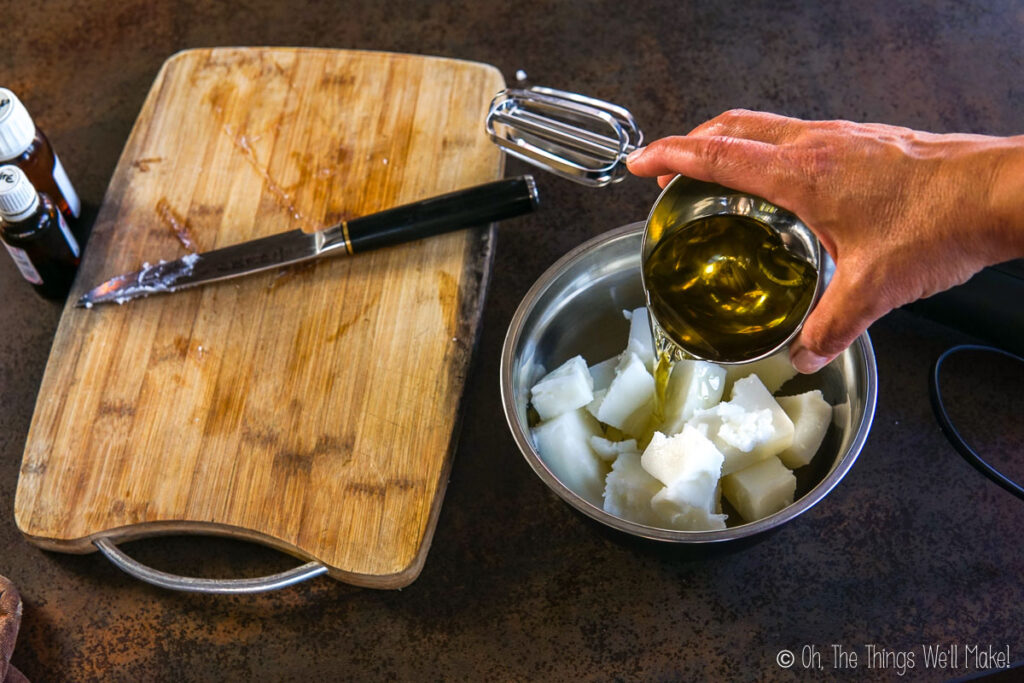 pouring oil into a bowl with tallow