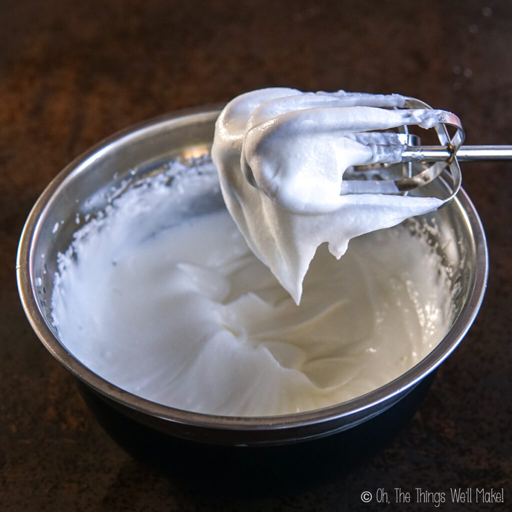 whipped tallow in a bowl with a beater over the bowl