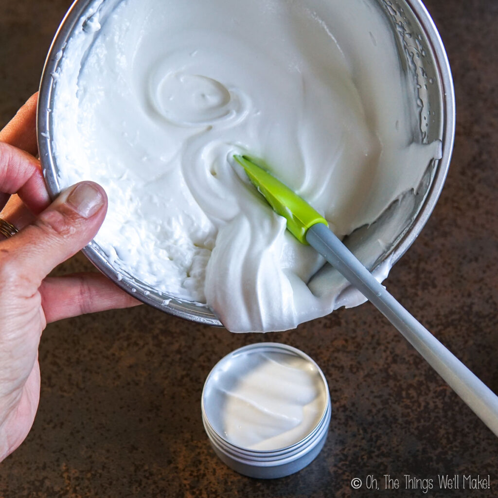 Pouring the whipped tallow into a metal tin
