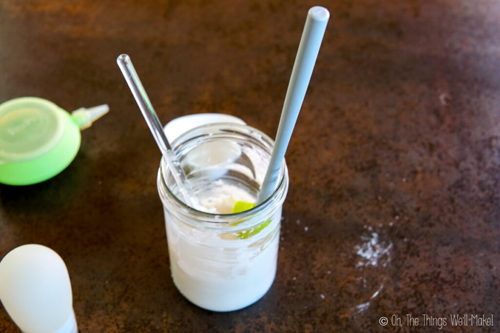 a glass jar filled with homemade toothpaste