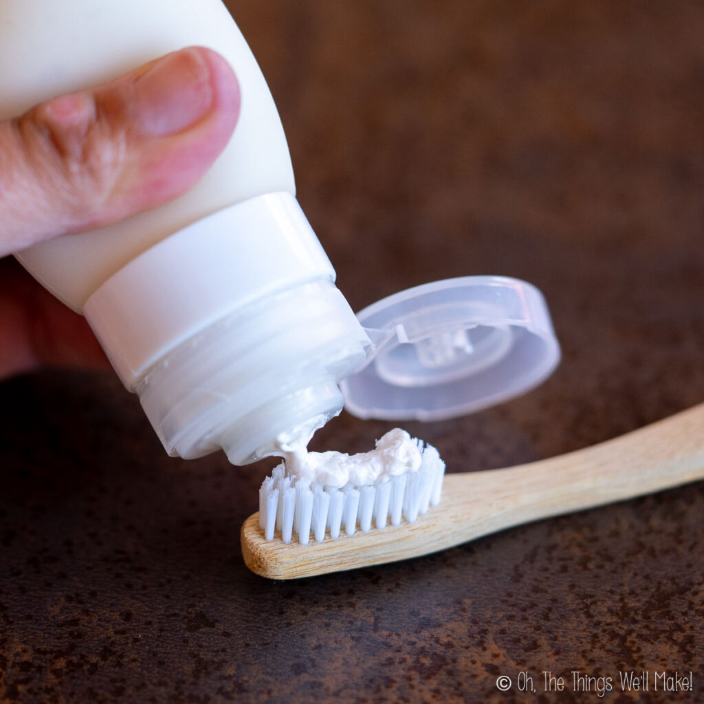 dispensing toothpaste onto a toothbrush