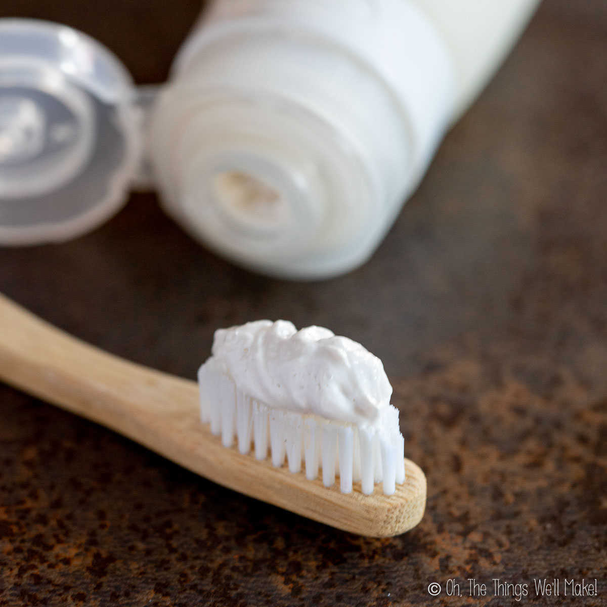 homemade toothpaste on a bamboo toothbrush