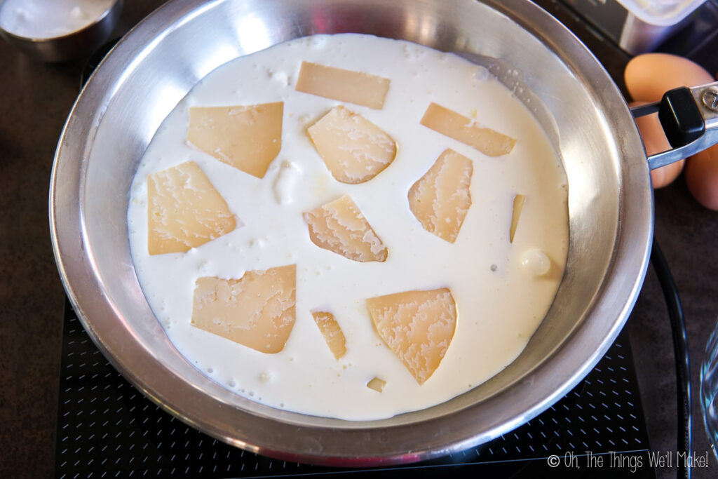 Manchego cheese in heavy cream in a pan