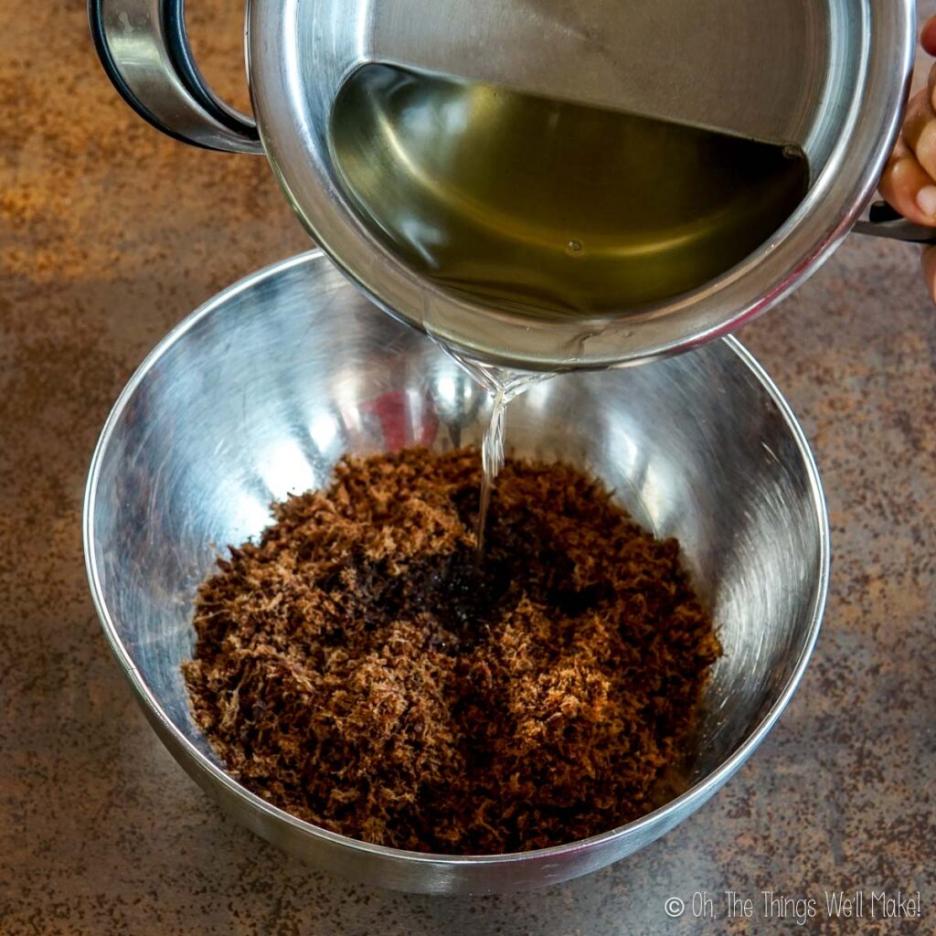 pouring melted tallow into a bowl with dried meat powder