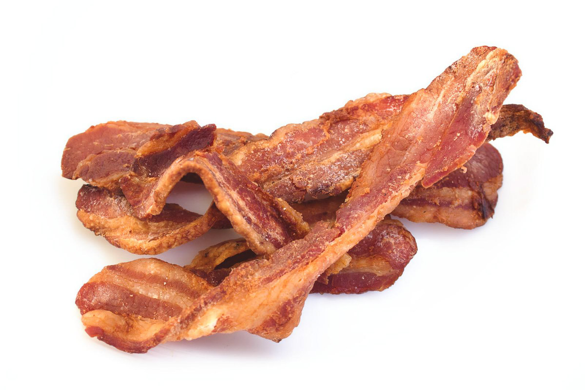 crispy bacon pieces on a white background