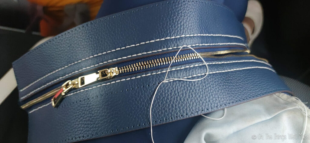 sewing the leather strips to the zipper