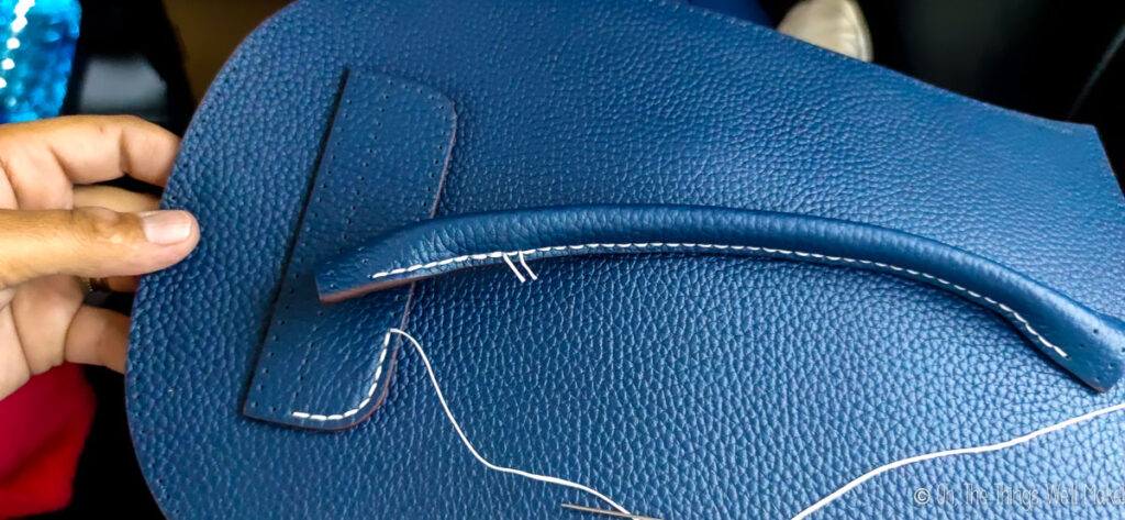 leather strap on back of backpack