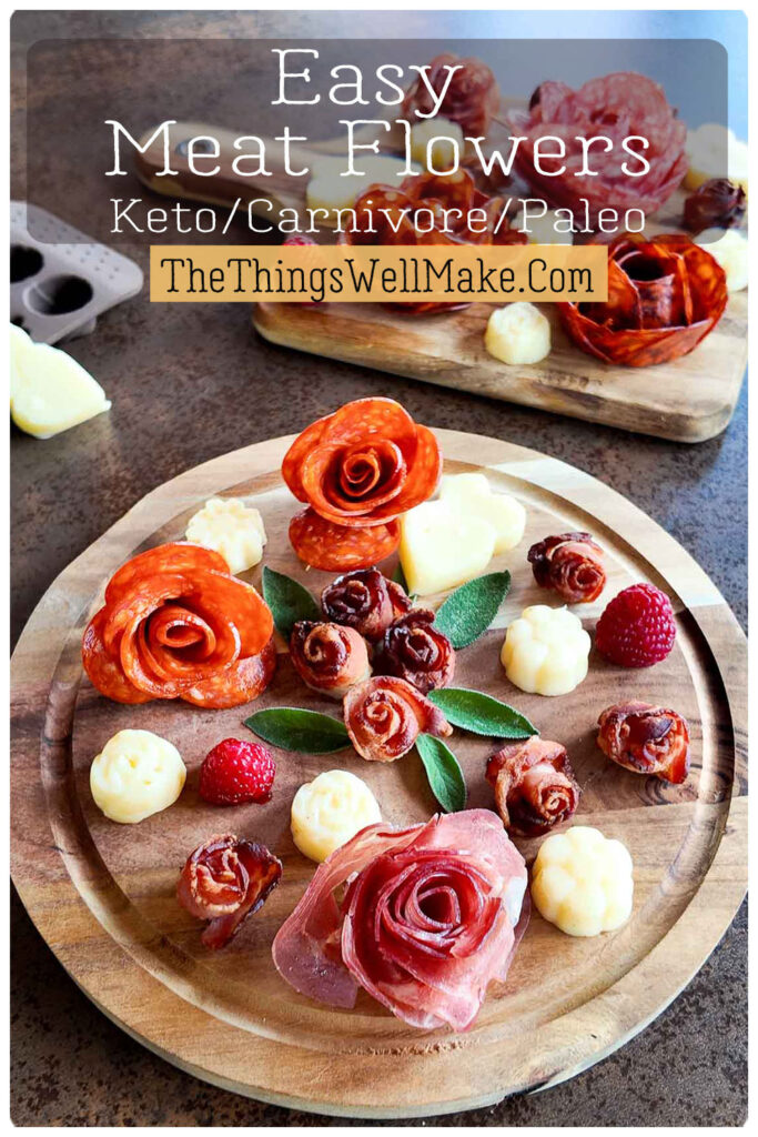 Wooden plates display intricate meat and cheese flower arrangements, garnished with raspberries and herbs. Text reads, "Easy Meat Flowers Keto/Carnivore/Paleo. TheThingsWellMake.com.
