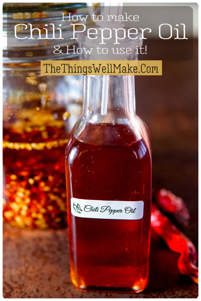 A glass bottle labeled "Chili Pepper Oil" with a vibrant red oil stands beside a jar with chili peppers and oil.