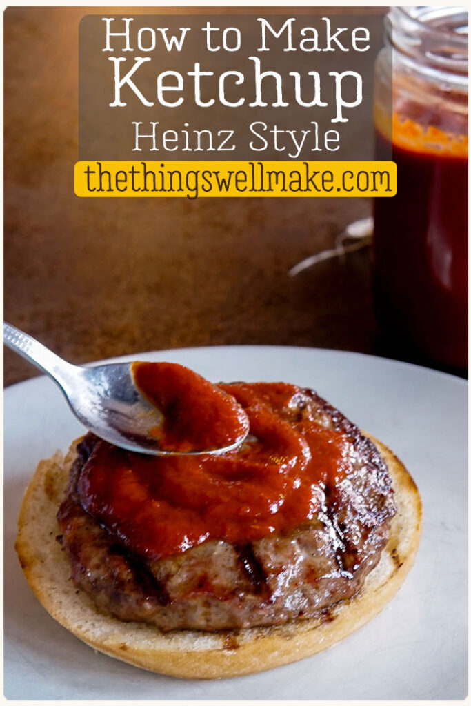 A spoon spreads ketchup onto a hamburger patty on a bun, with a jar of ketchup in the background. Text reads: "How to Make Ketchup Heinz Style thethingswellmake.com".