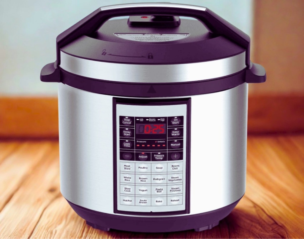 A stainless steel electric pressure cooker sits on a wooden surface, displaying a digital timer set to 25 minutes.